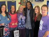 Special guest Benjamin Zephaniah with organiser Mark Gold, choir leader Alise Ojay, and hardworking helpers.